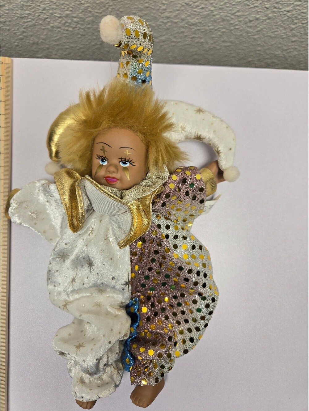 Harlequin clown doll in white and gold costume